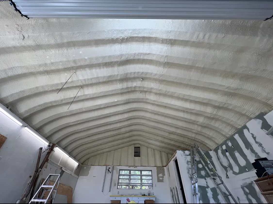 Spray polyurethane foam applied to the underside of a metal roof deck in Cleburne